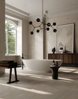 Modern bathroom with a freestanding bathtub, wooden cabinet, and decorative lighting fixture.