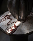 Vase on a calacatta marble top side table with a dark background from 101 Copenhagen at Spacio retail stores in Mumbai & Kolkata.