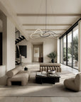 Modern living room with stone wall, large windows, and stylish furniture.
