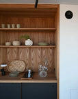 Wooden shelf with decorative items in a kitchen setting