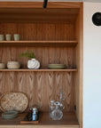 Wooden shelf with decorative items in a kitchen setting