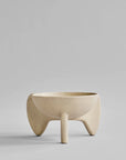 Beige ceramic bowl on a gray background from 101 Copenhagen at Spacio retail stores in Mumbai & Kolkata.