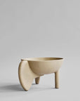 Beige ceramic bowl with unique design on a gray background from 101 Copenhagen at Spacio retail stores in Mumbai & Kolkata.