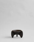 Small black ceramic bowl on a light gray background from 101 Copenhagen at Spacio retail stores in Mumbai & Kolkata.
