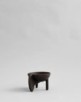 Black ceramic cup with a unique design on a light gray background from 101 Copenhagen at Spacio retail stores in Mumbai & Kolkata.