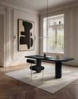 Modern office with a black desk and abstract art on the wall