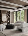 Modern living room with gray sofa, coffee table, and bookshelf.