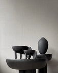 Set of black ceramic sculptures on a neutral background
