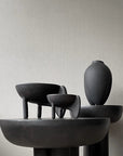 Set of black ceramic sculptures on a neutral background