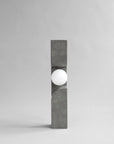 Modern outdoor floor lamp with concrete base and white globe on a gray background from 101 Copenhagen at Spacio retail stores in Mumbai & Kolkata.