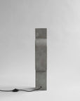 Rectangular concrete block with a black cord on a white background from 101 Copenhagen at Spacio retail stores in Mumbai & Kolkata.