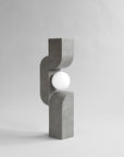 Concrete lamp with a spherical light bulb on a gray background from 101 Copenhagen at Spacio retail stores in Mumbai & Kolkata.