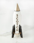 Jonathan Adler Rocket Scotch Decanter with silver pointed top and black star-accented fins, high-fired porcelain, available at Spacio India