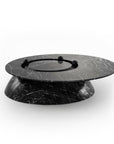 Black marble-like round object on a white background