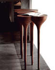 An Agrippa Esgrimas Console table with simple shapes and a book on it.
