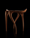 Wooden stool with a unique design on a black background