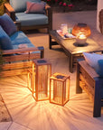 Outdoor patio setting with wooden furniture and solar lanterns by Les Jardins available at Spacio retail stores in Mumbai & Kolkata.