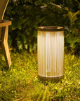 Garden solar lantern on grass with bench and plants in the background by Les Jardins available at Spacio retail stores in India.