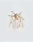 A wall light with glass droplets in clear and gold colour hanging from gold finish branches on a light grey colour background
