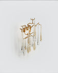 Side view of a wall light with glass droplets in clear and gold colour hanging from gold finish branches on a light grey colour background