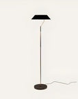 Floor lamp with black shade and gold base on a white background from Aromas Del Campo available at Spacio retail stores in Mumbai & Kolkata.