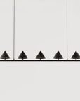 Modern pendant light fixture with five black conical shades on a white background from Aromas Del Campo, available at Spacio retail stores in Mumbai & Kolkata.