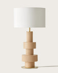 A modern design table lamp in beige colour on a light cream colour background from Aromas Del Campo available at Spacio retail stores in Mumbai & Kolkata.