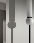 Close up of Aroma Del Camopo's Delie wall light showing the details of marble, metal and opal glass