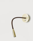 A wall light fixture in metal on a light grey back ground