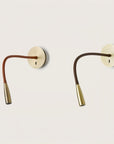 A pair wall light fixtures in metal and different colours of leather on a light grey back ground from the Flexi collection of Aromas Del Campo available at Spacio retail stores in India.
