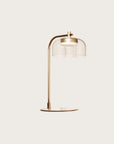 A modern design table lamp in brass and clear glass from Aromas Del Campo available at Spacio retail stores in Mumbai & Kolkata.
