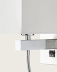 Close up of a wall light with white fabric shared on a light cream colour background