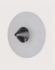 A wall light in black marble and alabaster from Aromas Del Campo available at Spacio retail stores in Mumbai & Kolkata