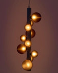 A decorative suspension lamp hanging from the ceiling, by Aromas Del Campo available at Spacio retail stores in Mumbai & Kolkata on a dark background.