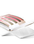 Side angle of Transparent Assouline Bookstand with a Book on a white background at Spacio India for luxury home decor collection of Coffee Table Books.