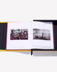 Open book with images of a Formula 1 car and a group of people on a white background