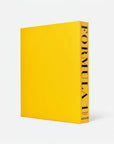 Yellow book titled 'Formula 1' by Assouline on a white background