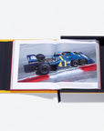 Open book showing a racing car on a white background