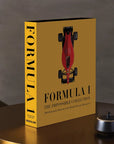 Book titled 'Formula 1: The Impossible Collection' with a red racing car on a yellow background.