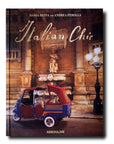 An Assouline Coffee Table Book Italian Chic that exudes beauty and style showcasing a red car in front of a charming fountain.