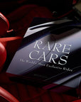 Close-up of a car interior with a 'Rare Cars' magazine cover.