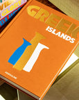 Assouline Greek Islands book placed among a curated collection of luxury travel books, displayed elegantly at Spacio India.