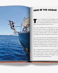 Captivating page spread titled "Gems of the Aegean" featuring lifestyle imagery from Assouline's Greek Islands book, at Spacio India.