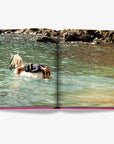 Serene image of woman relaxing on horseback in clear Mediterranean waters from Assouline's Ibiza Bohemia Luxury Coffee Table Book at Spacio India.