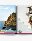 Scenic coastal view and fashionable woman with flowers embodying Ibiza's luxury bohemian style in Assouline Ibiza Bohemia at Spacio India.