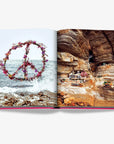 Striking peace sign floral arrangement and cliffside meditation scene featured in Ibiza Bohemia by Assouline, luxury travel book at Spacio India.