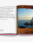 Assouline Ibiza Bohemia book page featuring inspiring quote and breathtaking view of Es Vedrà island through a rock frame, offered at Spacio India.