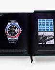 Assouline Impossible Rolex Coffee Table Book open on iconic Rolex watch page and aviation memorabilia, luxury decor available at Spacio India.