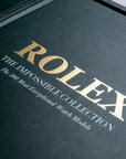 Elegant gold lettering on the green leather-bound Assouline Impossible Rolex coffee table book, luxury decor available at Spacio India.