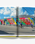 Bold and colorful Miami street art mural with 'Remember Paradise' painted across a lively urban wall. A stunning feature from the Assouline Coffee Table Book Miami Beach, available at Spacio India.